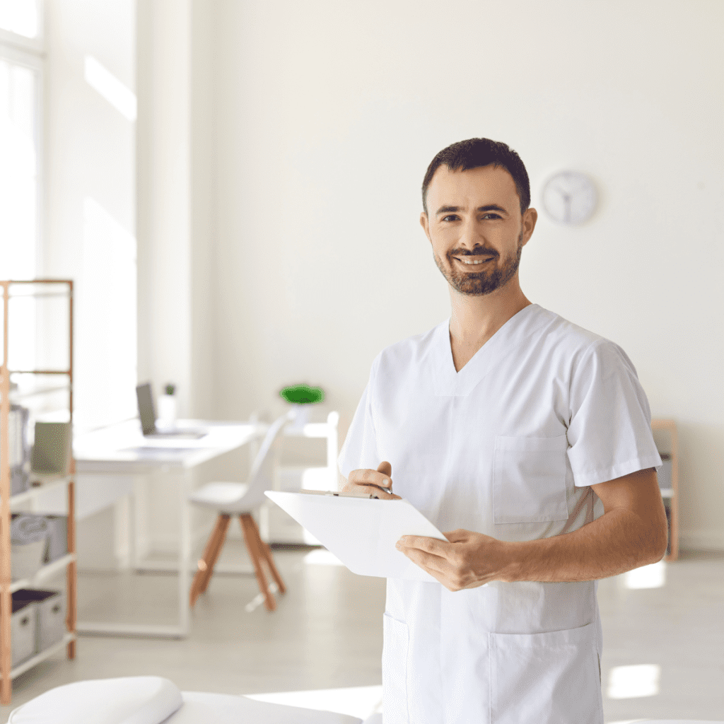 A smiling Pioneer travel therapy specialist holding a clipboard in a bright clinical 