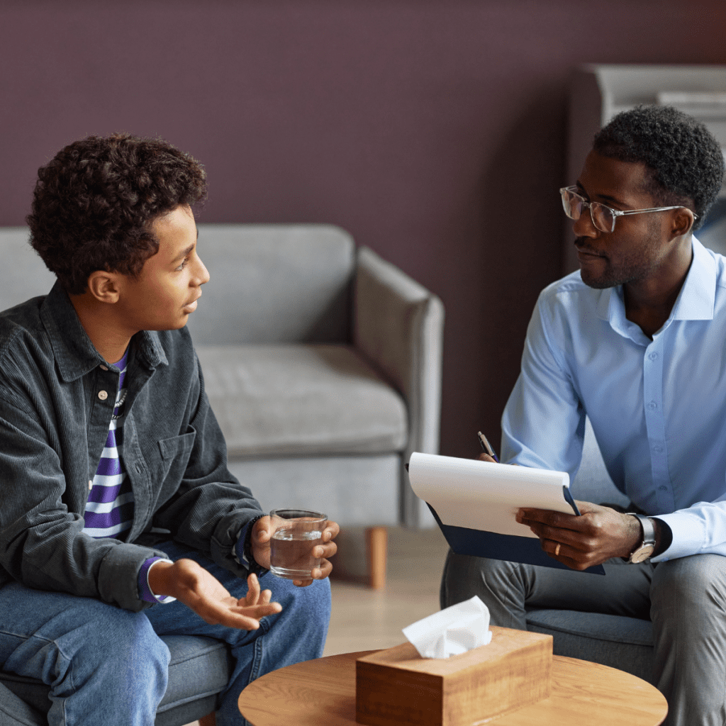 Psychologist reviewing notes with a patient during a one-on-one therapy session