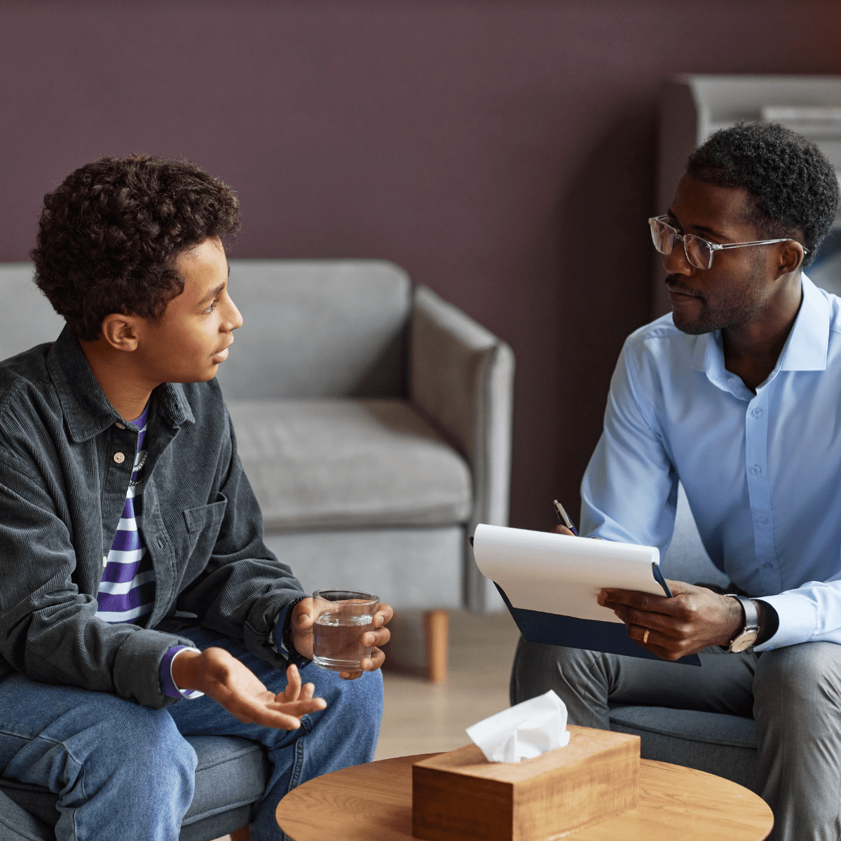 Psychologist reviewing notes with a patient during a one-on-one therapy session