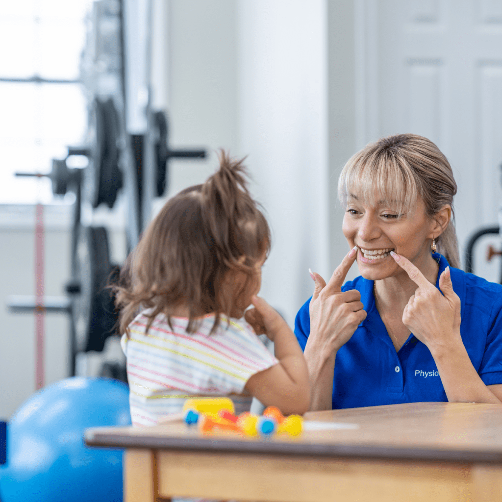 A pediatric specialist engaging a young child in speech exercises, illustrating high-demand opportunities in early intervention and pediatric clinics. 